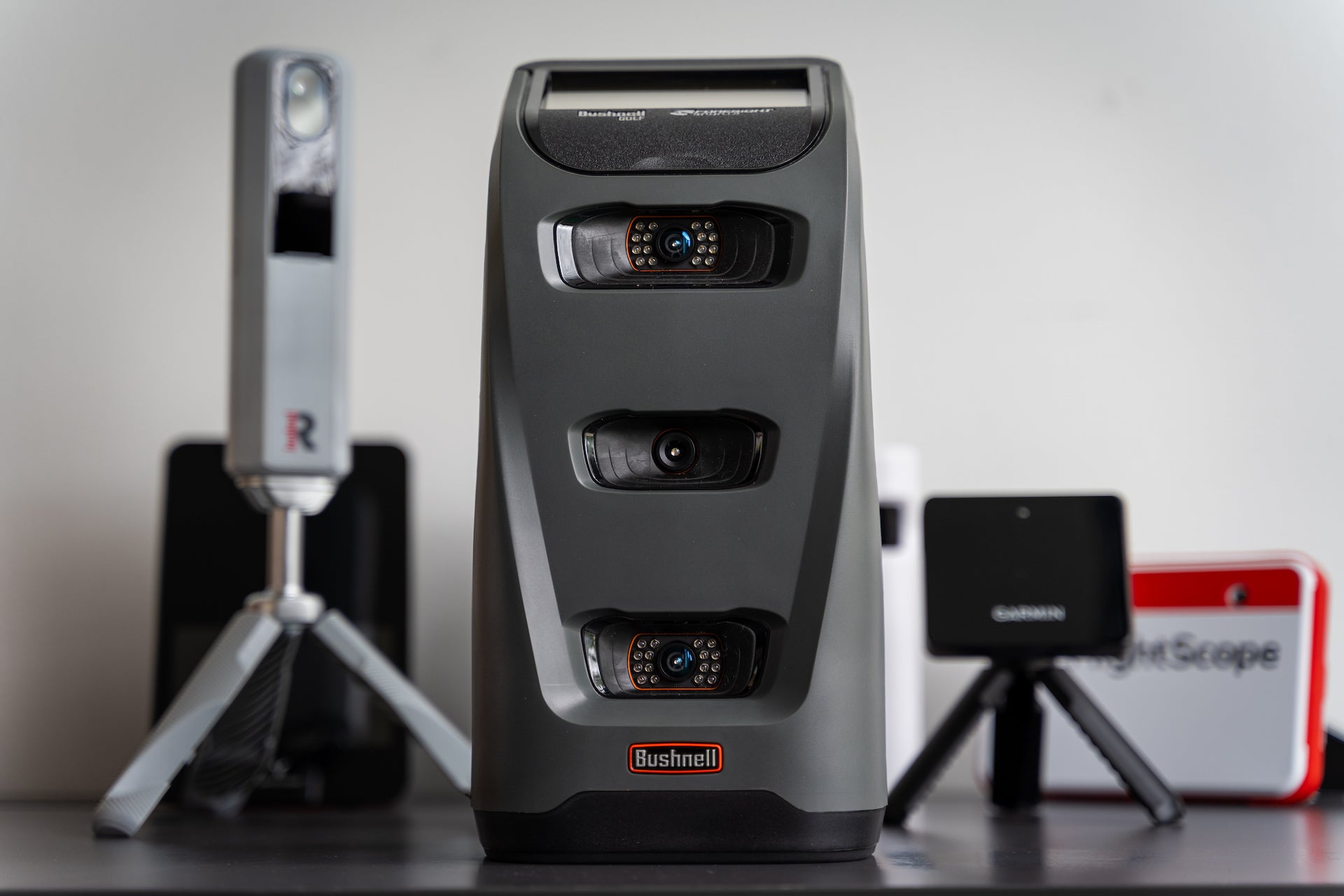 The Bushnell Launch Pro in front of several other golf launch monitors at PlayBetter