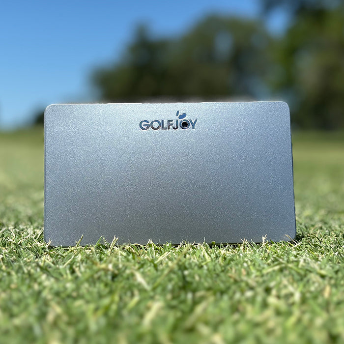 The Silver GolfJoy Golf Waver launch monitor sitting on the grass at the golf course (photo by PlayBetter golf reviewer Marc)