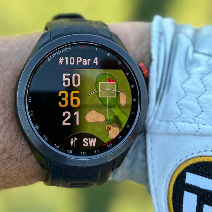 The Black Garmin Approach S70 size 47 mm golf watch on Marc's wrist with a white golf glove