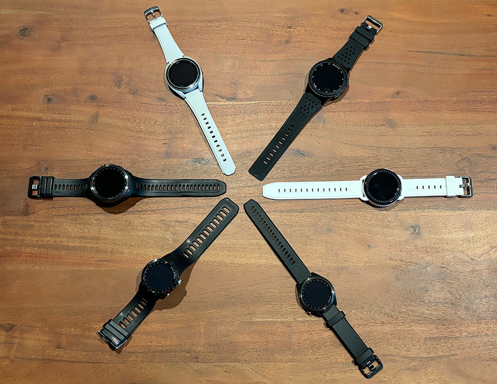 Six white and black golf watches in a star shape on a hardwood floor