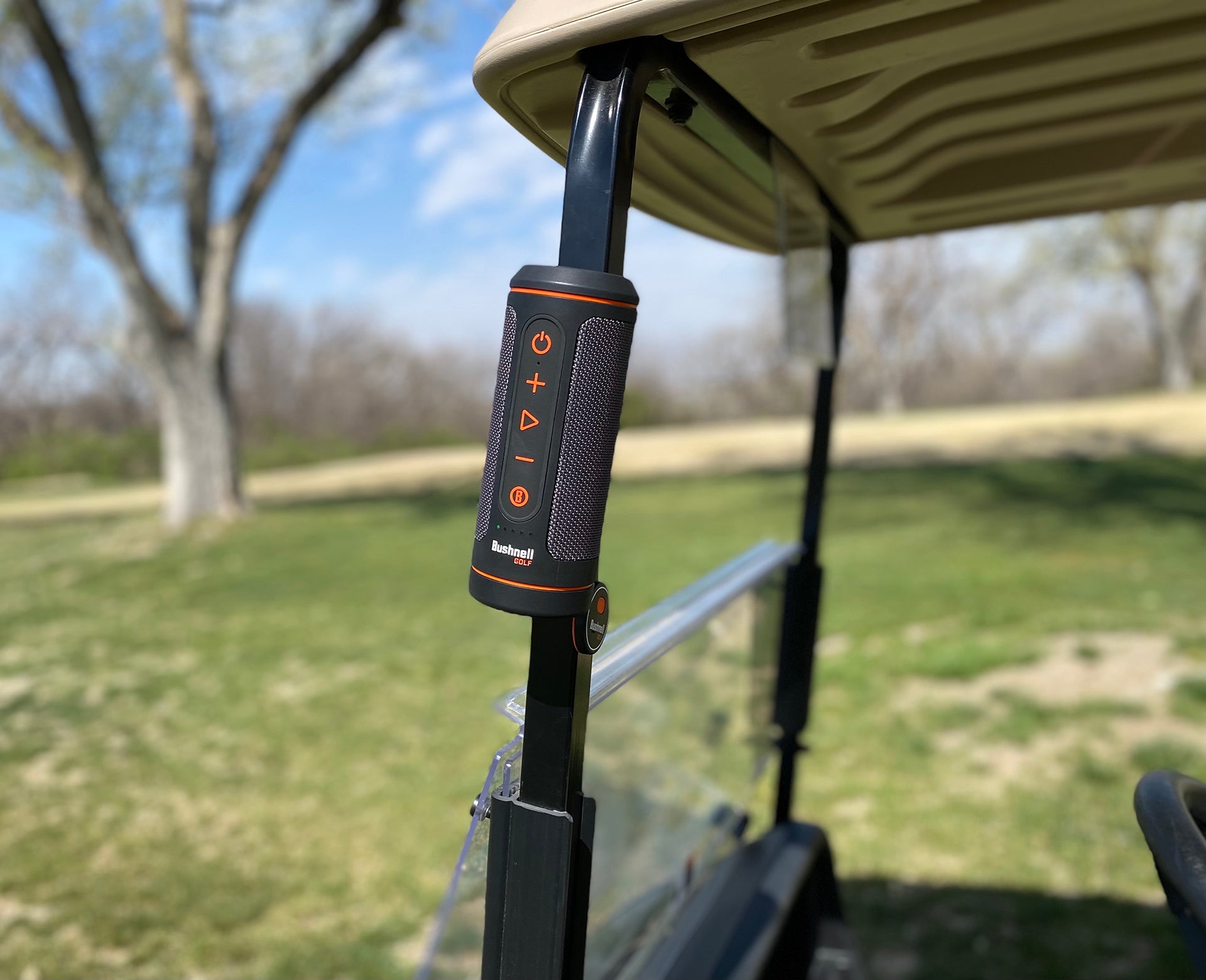 The Bushnell Wingman 2 golf speaker stuck to a golf cart pole by the magnet