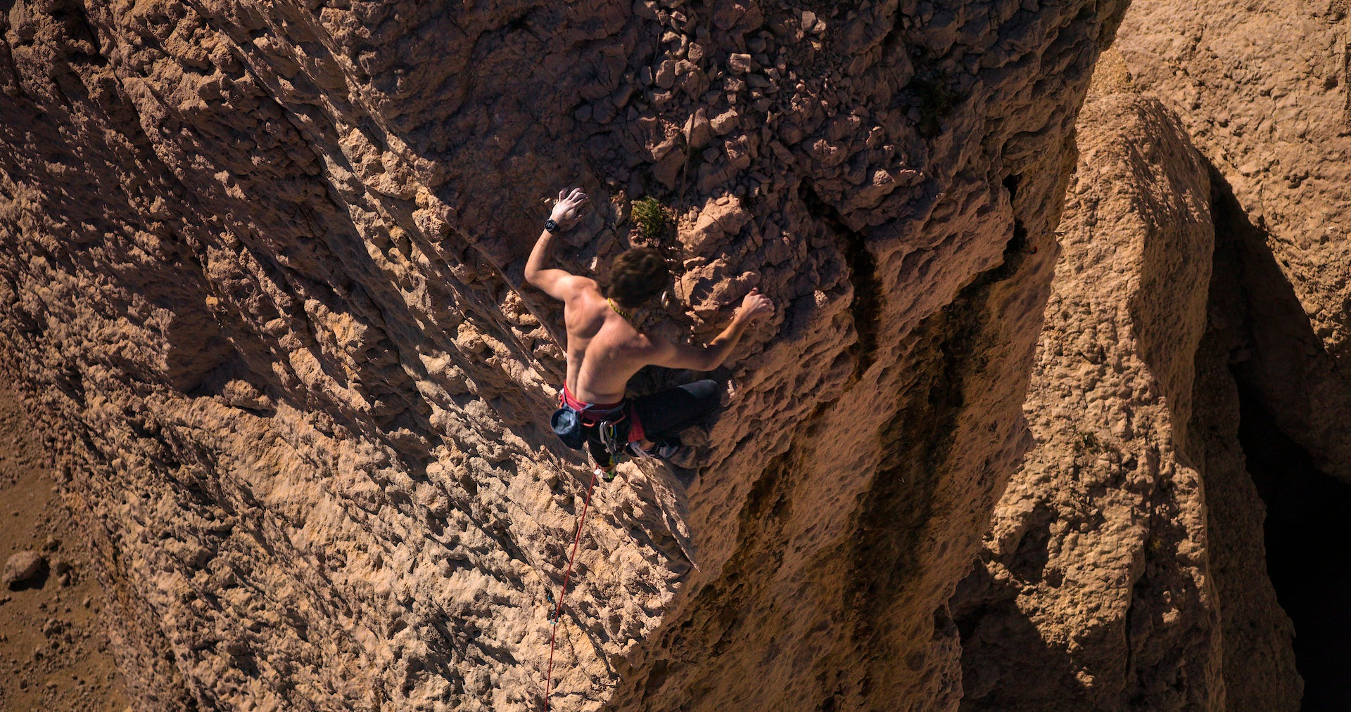 A man rock climbing with a Garmin fenix 8 multisport watch on his wrist 