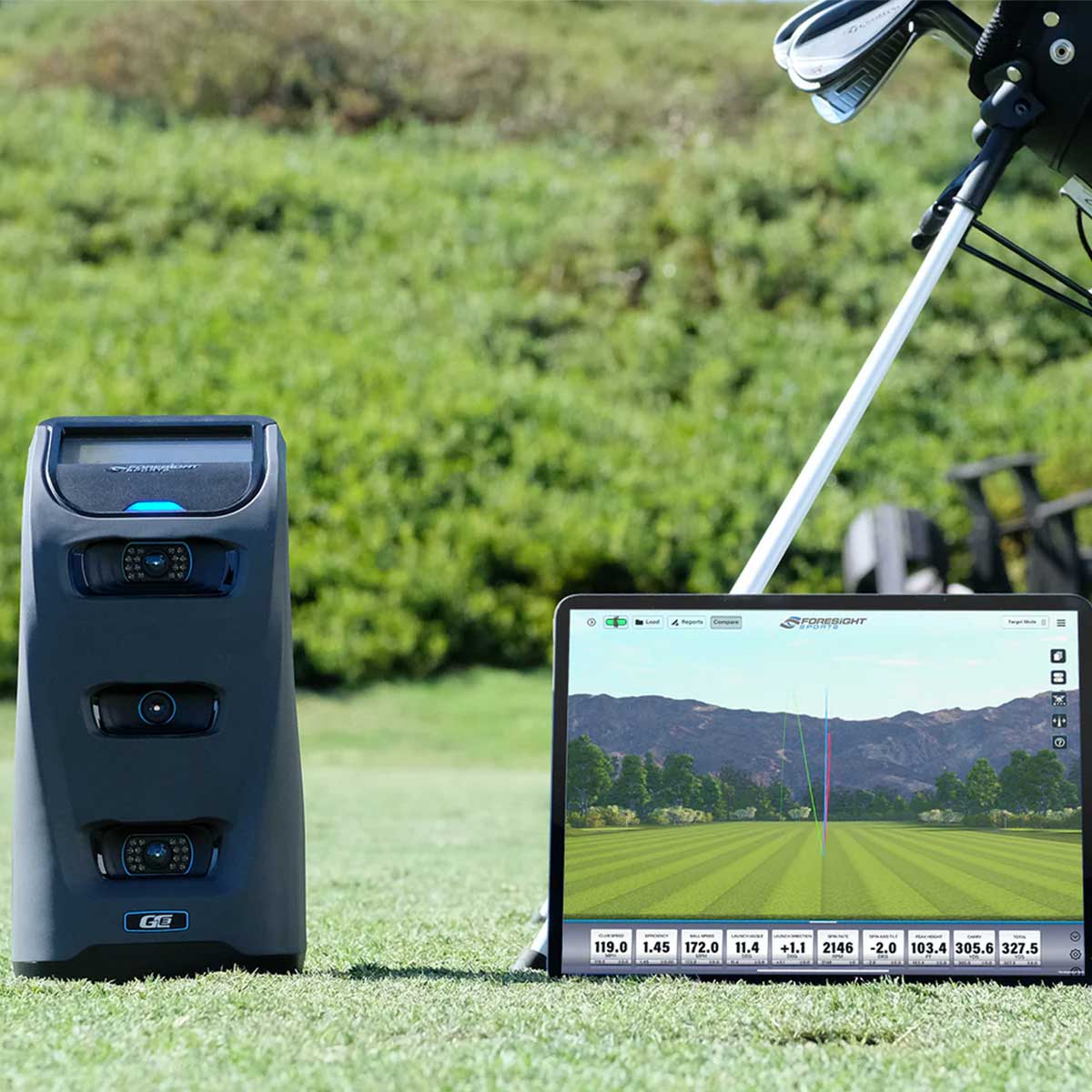 The Foresight Sports GC3 launch monitor on the golf course next to a laptop with FSX Play software on the screen with a golf stand bag partially shown in the background