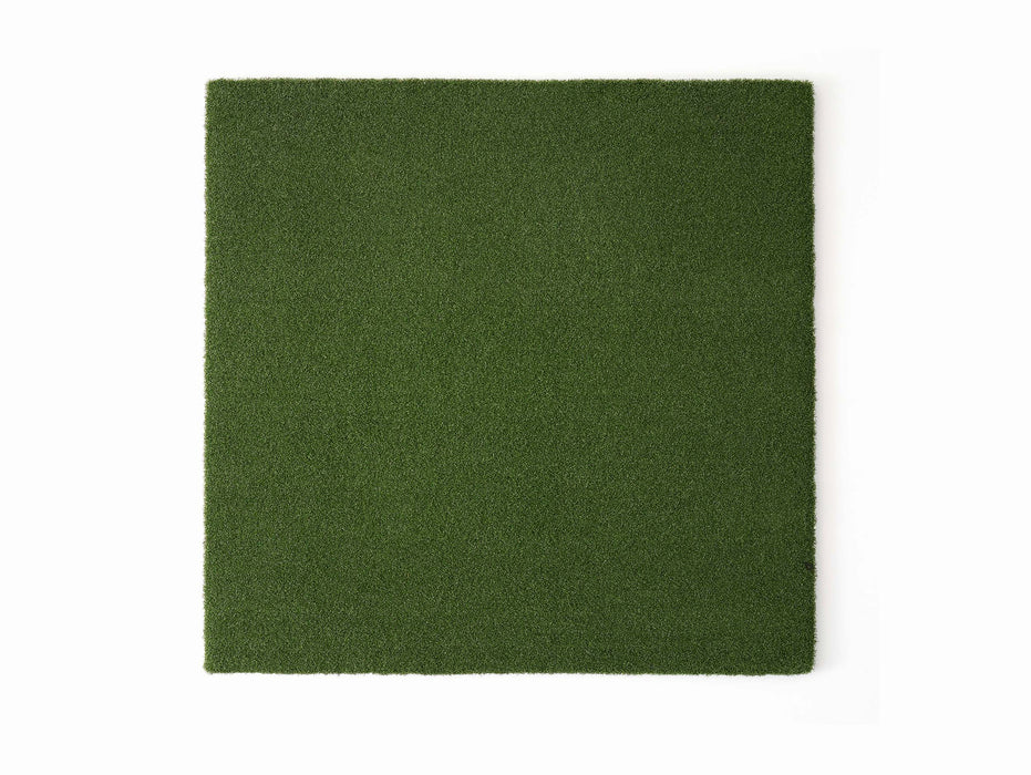 A top view of a square golf hitting mat